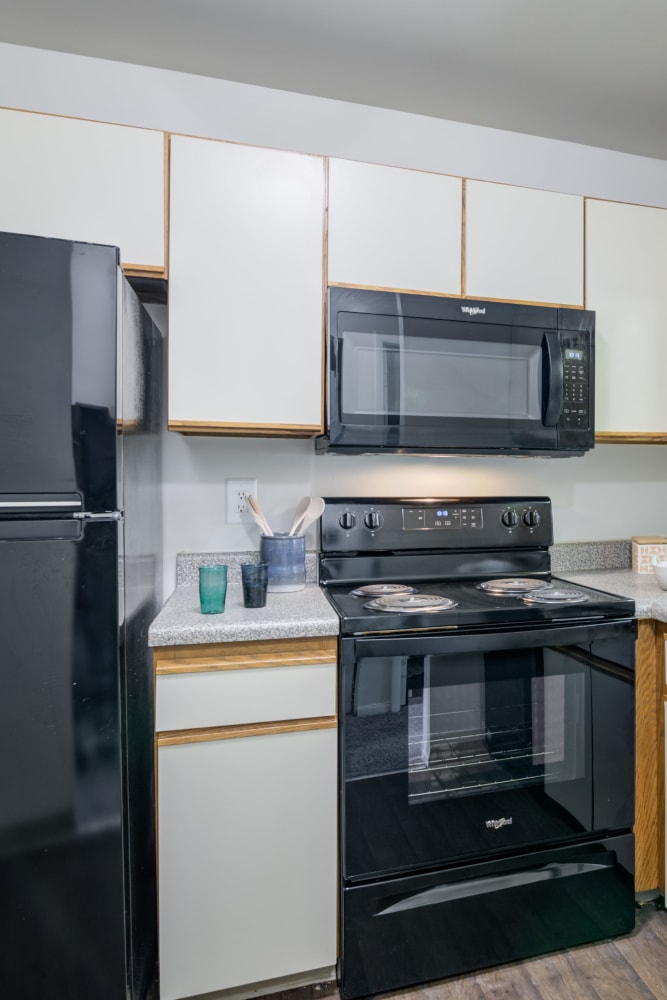 Classic kitchen with black appliances at Tory Estates Apartment Homes in Clementon, New Jersey