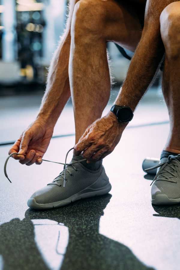 Resident tying shoe in gym at Merrill Gardens at Sheldon Park