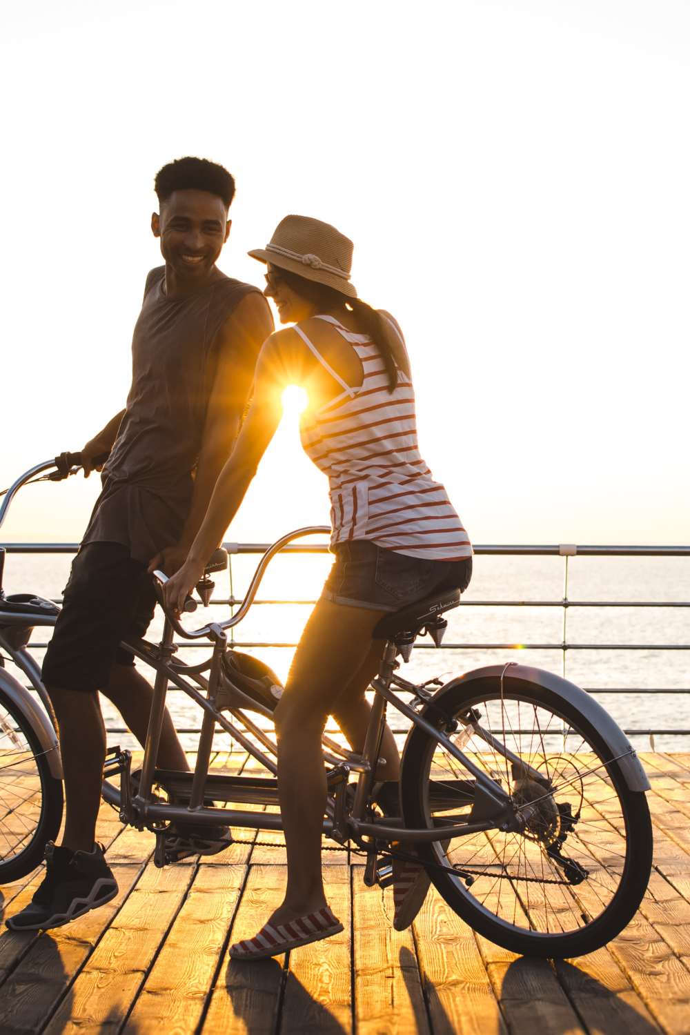Resident couple riding their bikes on the boardwalk at Avion Apartments in Jacksonville, Florida