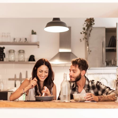 A couple having a meal in a kitchen at Bard Estates in Port Hueneme, California