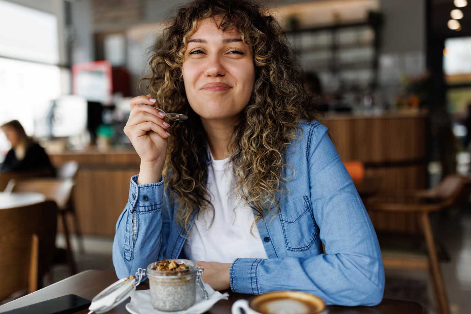 Resident eating in a cafe near The Pines At Peach Road in Raleigh, North Carolina