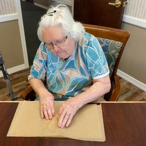 Resident showing off her craft project at Homestead House in Beatrice, Nebraska