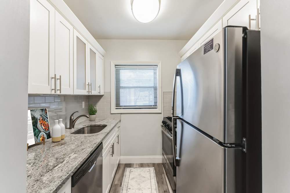Stainless steel appliances and granite countertops at Eagle Rock Apartments at Hicksville/Jericho in Hicksville, New York
