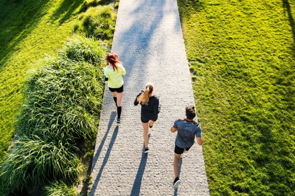 Three residents running on a trail near Canyon Grove in Grand Prairie, Texas