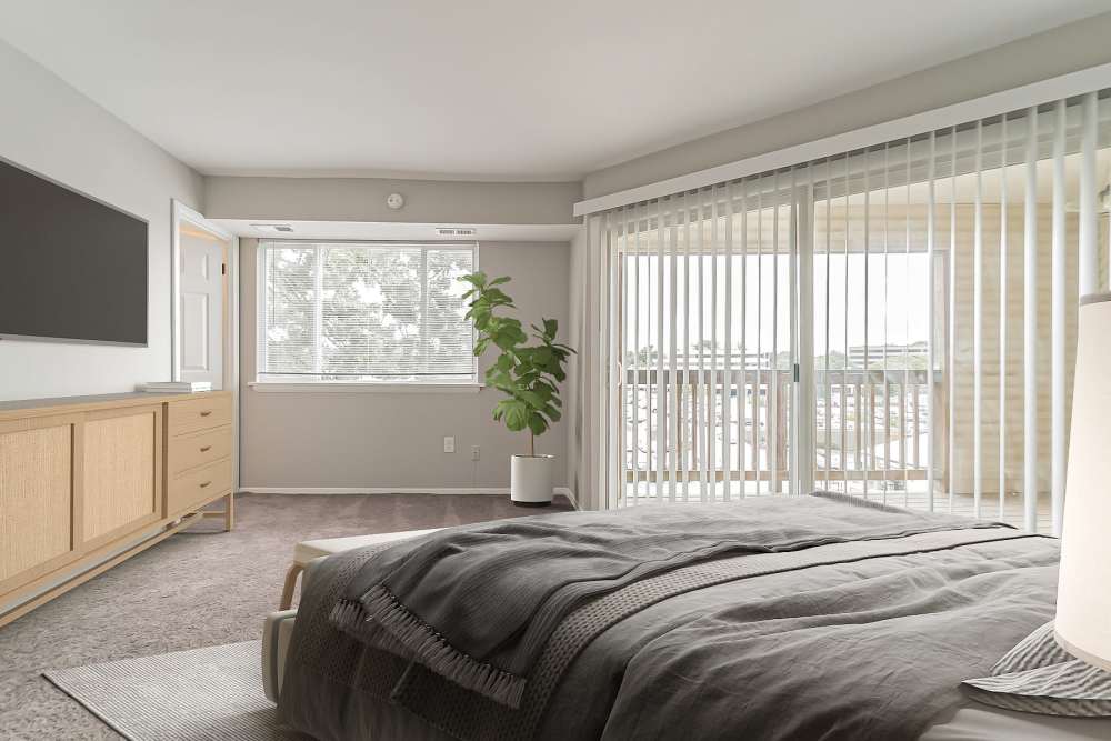 Modern bedroom with access to private balcony at Eagle Rock Apartments at Towson in Towson, Maryland