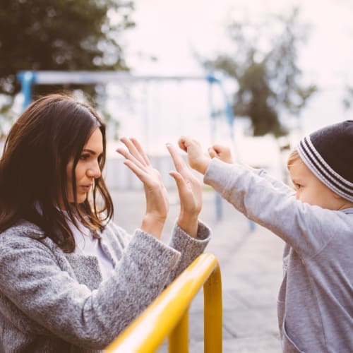 A mother and her child playing at a playground near Miramar Milcon in San Diego, California