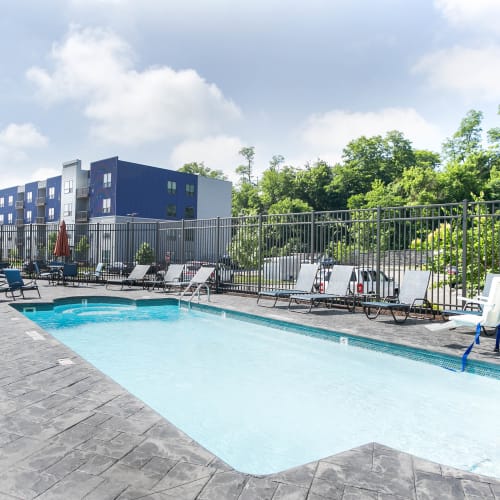 Outdoor seating and heated swimming pool at Park West 205 Apartment Homes in Pittsburgh, Pennsylvania