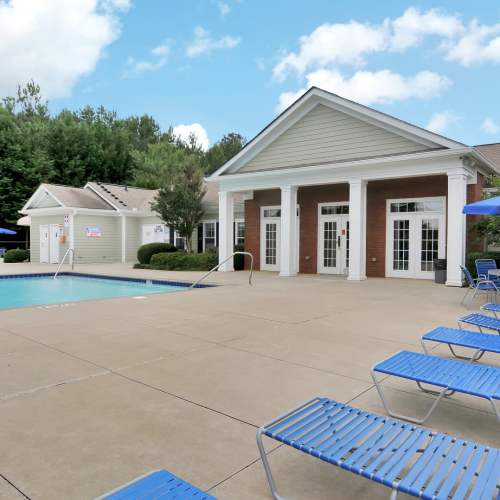 Swimming pool with laid back chairs at Cherokee Summit Apartments in Acworth, Georgia