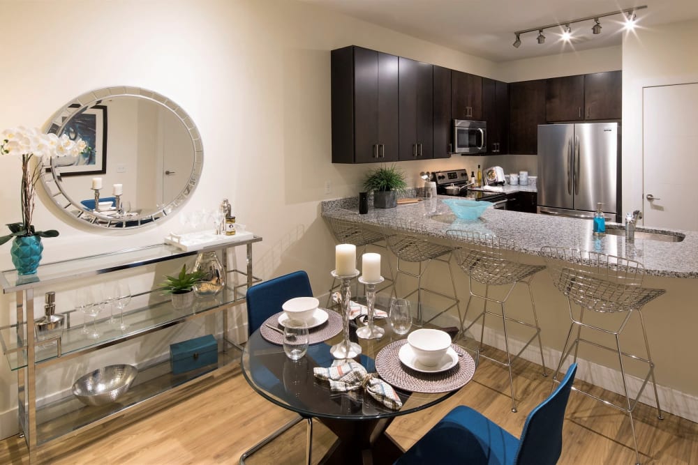 Dining area and open gourmet kitchen of an apartment at The Residences at Annapolis Junction in Annapolis Junction, Maryland