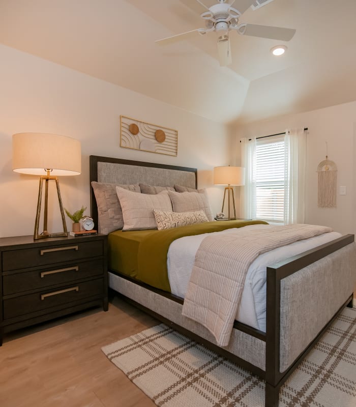 Model bedroom with natural accents and light at Chisholm Pointe in Oklahoma City, Oklahoma