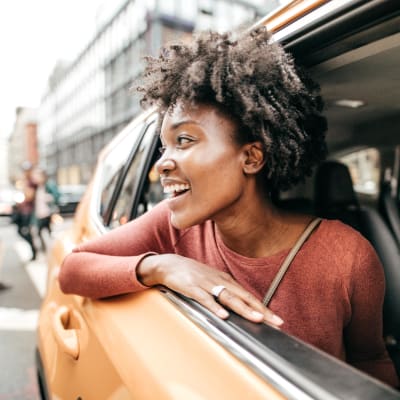 Woman taking a taxi around town and enjoying the views near Alley South Lake Union in Seattle, Washington