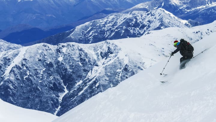 A person skiing on a mountain range