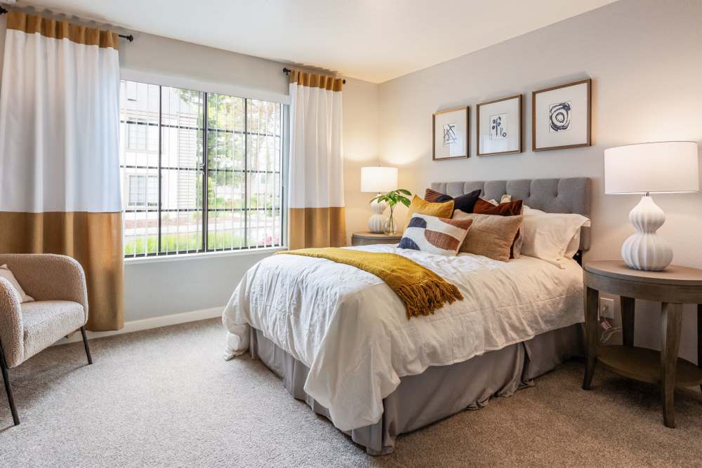 Bedroom with large windows for natural lighting at Hidden Lake Condominium Rentals in Sacramento, California