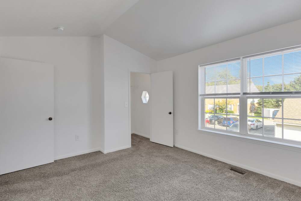 Bedroom with gray carpet and white door at Timber Lake in Avon, Ohio