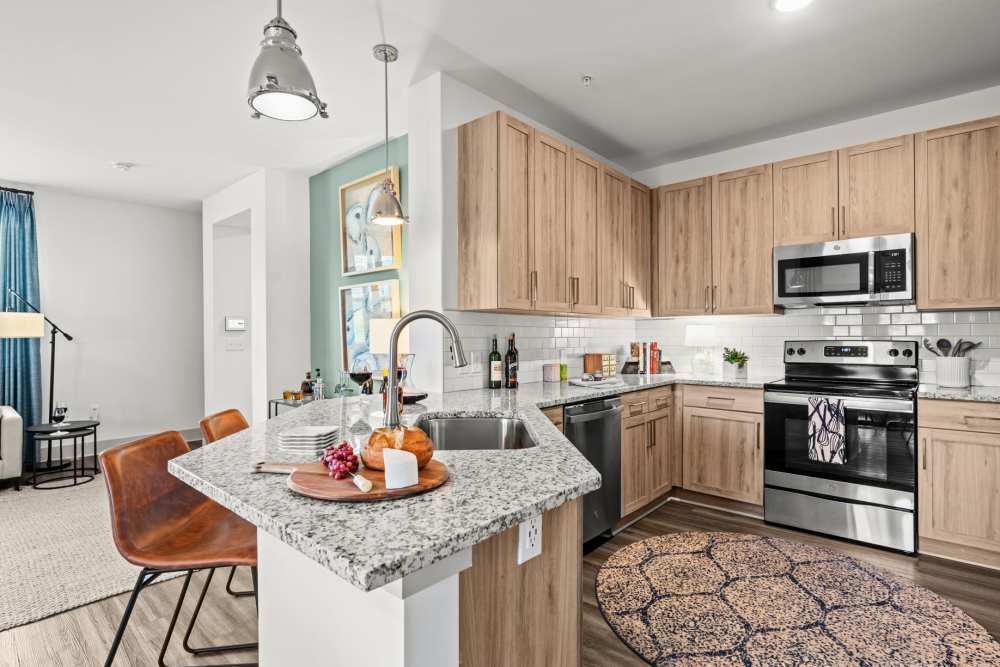 Bright kitchen with wood cabinet at Watersound Origins Crossings in Inlet Beach, Florida