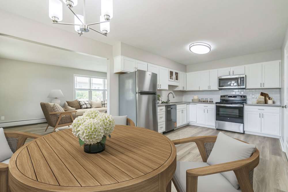 Dining area with view of the living room and kitchen at Northway Eleven, An Eagle Rock Community in Ballston Lake, New York