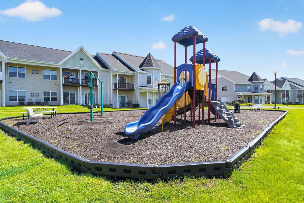 Playground with sliders at Mansions at Delmar, an Eagle Rock Community in Delmar, New York
