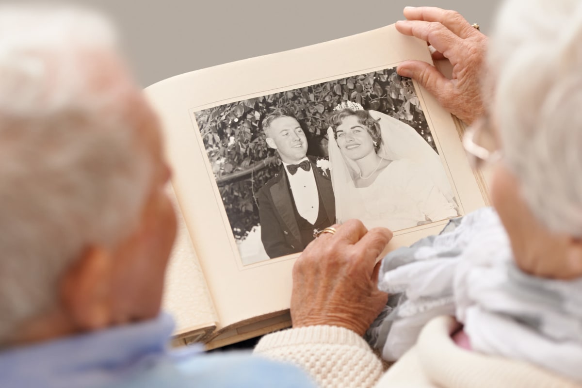 Two people looking at photos at Canoe Brook Assisted Living in Duncan, Oklahoma