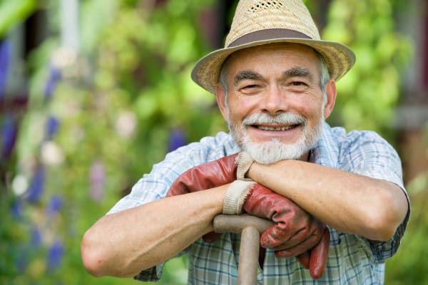 A resident smiling at the camera at The Groves, A Merrill Gardens Community in Goodyear, Arizona.