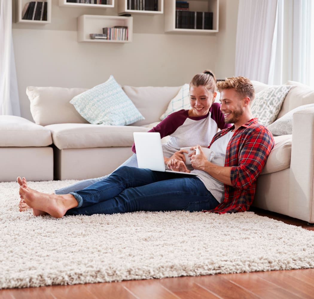 Couple relaxing in their Living Room at Sunchase Ridgeland Apartments in Ridgeland, Mississippi