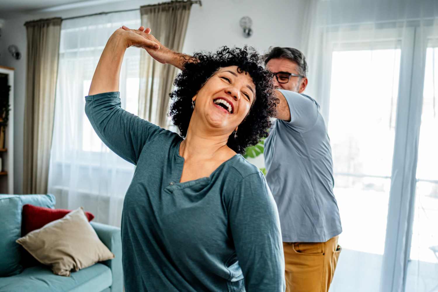 Resident couple dancing in their living room at Whispering Pines in Grayling, Michigan