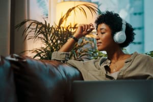 Resident listening to music in her home at Hawthorne Apartments in Palo Alto, California