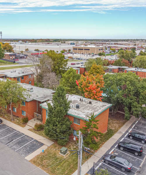 Resident with his kids playing at a park near Courtyard Apartments in Columbia, Missouri