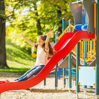 Kids playing on the slide in the play area at Madison at Schilling Farms in Collierville, Tennessee