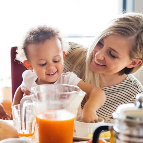 A resident and her child eating breakfast at Gela Point in Virginia Beach, Virginia