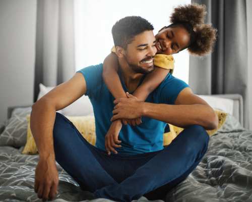 Resident spending some quality time with his daughter in a spacious bedroom at The Fowler in Boise, Idaho