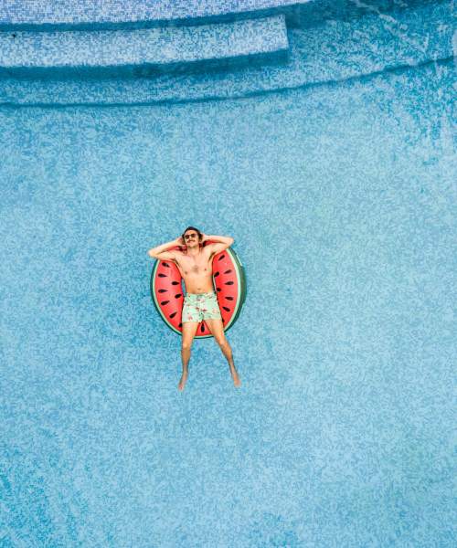 Resident enjoying in the swimming pool at 1729 Midtown in Lexington, Kentucky