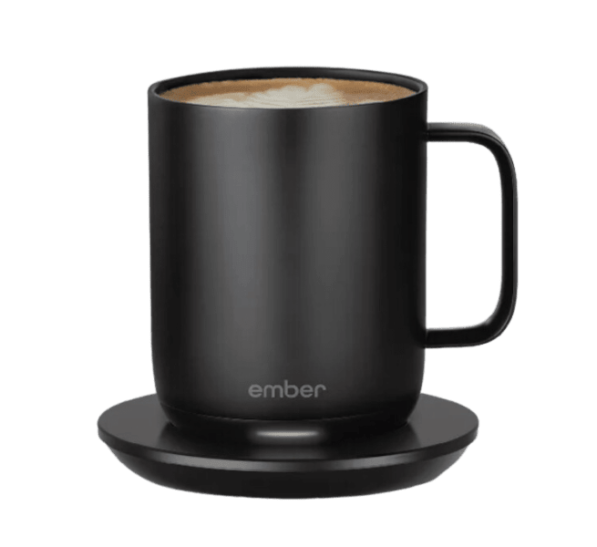 A black stainless steel mug on a black charging coaster