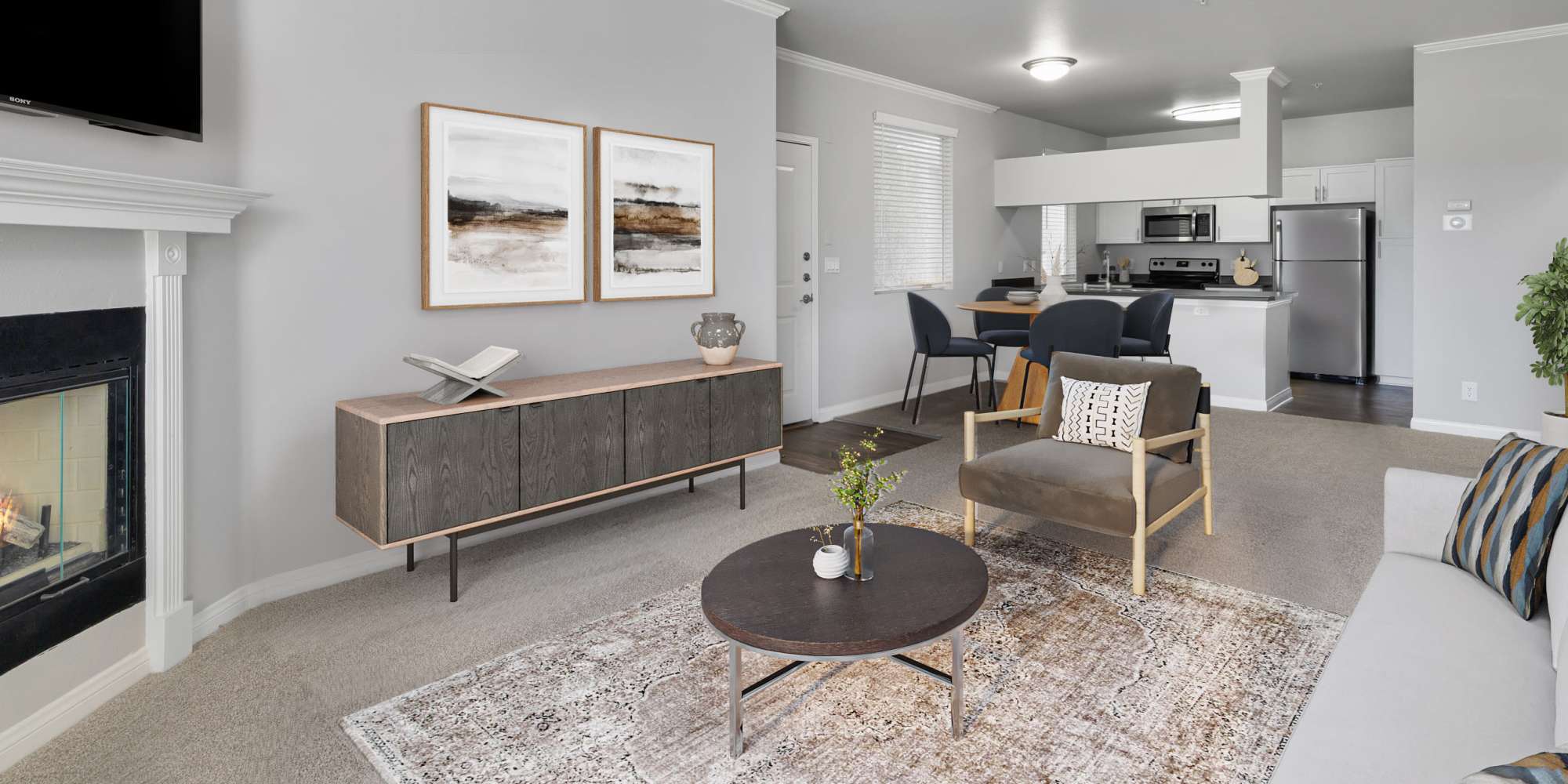 Living room with fireplace, dining room and upgraded kitchen at Alize at Aliso Viejo Apartment Homes in Aliso Viejo, California