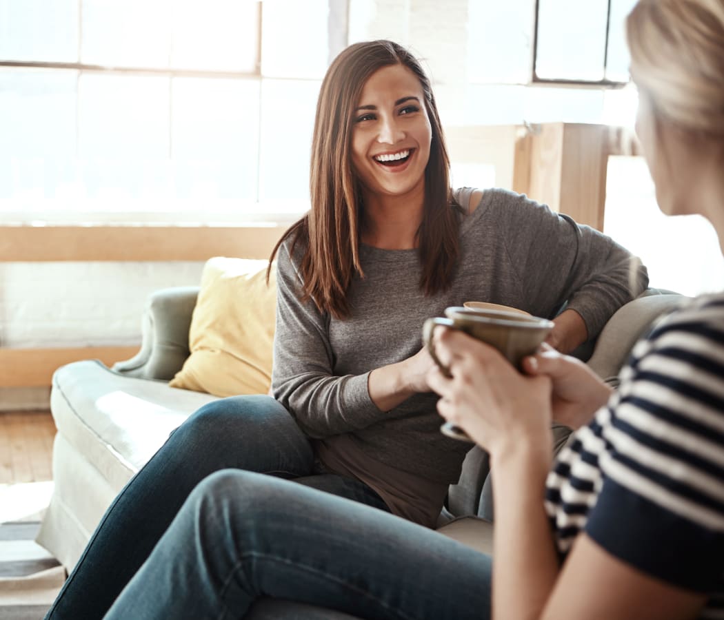 Friends enjoying coffee and conversation in their new home at Aspire at 610 in Houston, TX