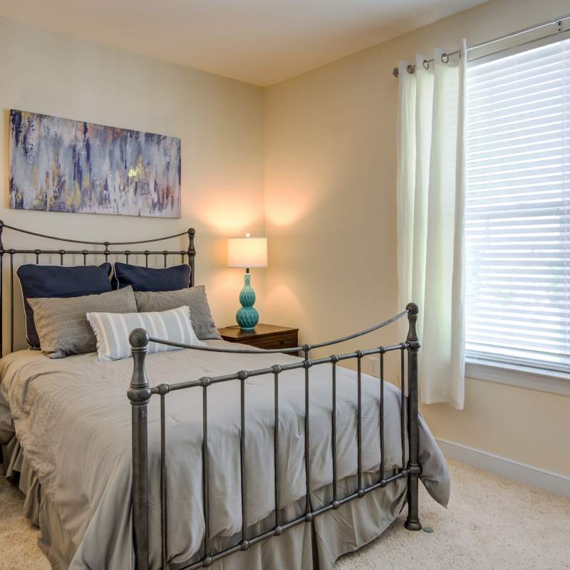 Model bedroom with window at The Carlton at Greenbrier, Chesapeake, Virginia