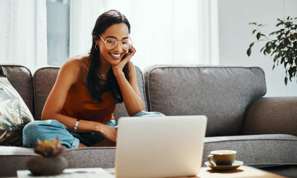 Resident relaxing at home with her laptop at Echo Park in Bloomington, Indiana