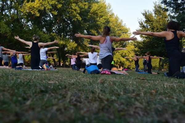 Residents doing yoga in a park near Dorian and Encore in Plano, Texas