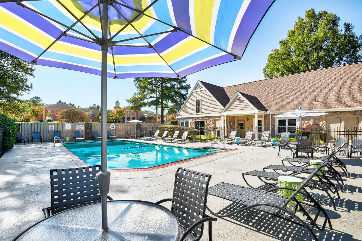 Swimming pool with umbrella at Farmington Gates in Germantown, Tennessee