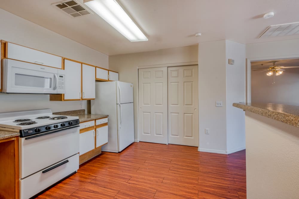 All white cabinets and appliances in this kitchen at Whispering Palms Apartments in North Las Vegas, Nevada