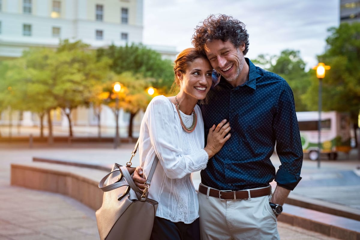 A couple strolling near The Gateway Apartments in Mobile, Alabama