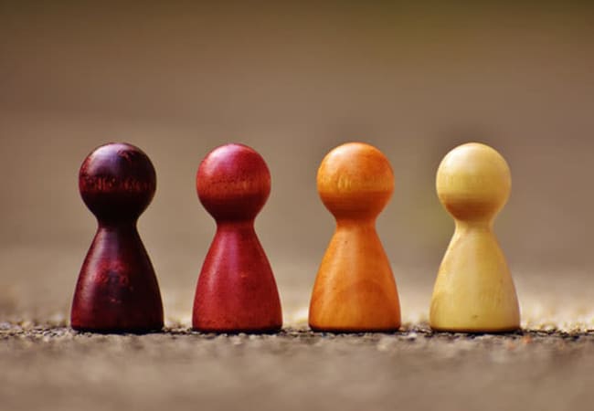 Group of wooden figures symbolizing teamwork at American Capital Group in Bellevue, Washington