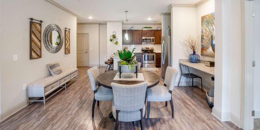 Dining room with wood-style flooring at Caliber at Hyland Village in Westminster, Colorado