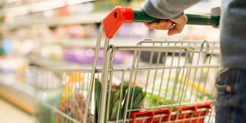 A resident pushing a cart at a grocery store near Dahlgren Townhomes in Dahlgren, Virginia