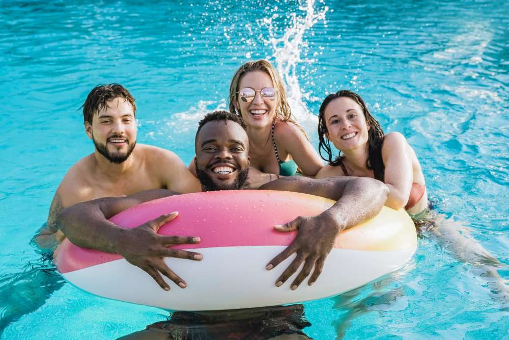 Resident friends enjoying in a pool area at Sherwood Pointe Apartments in Shawnee, Oklahoma