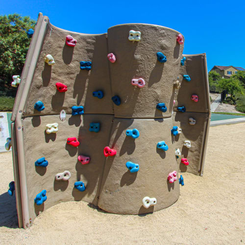 A climbing wall at a playground at Lofgren Terrace in Chula Vista, California
