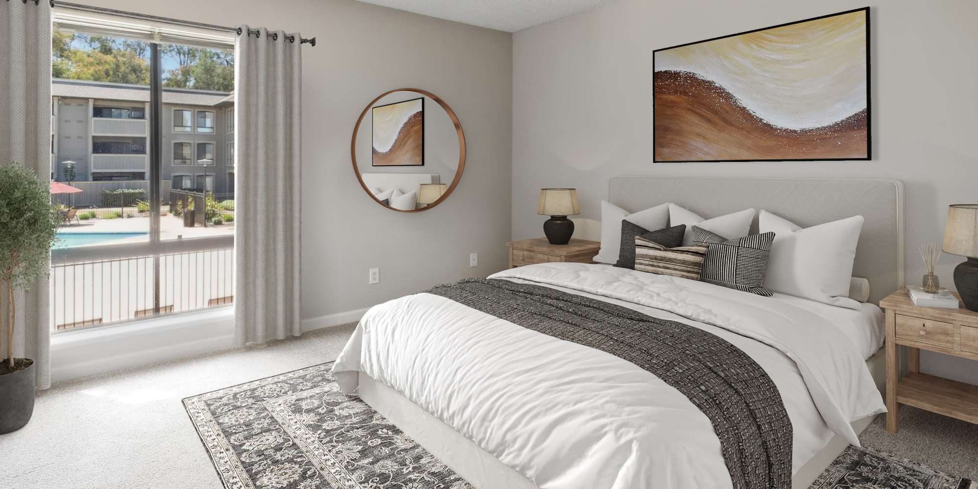 Bedroom with large window overlooking the pool area at Muirwood Apartment Homes in Martinez, California