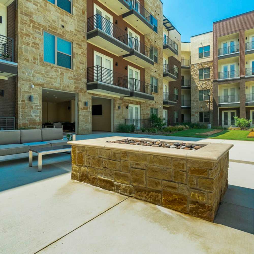 Community firepit area with seating at Millennium Place in Corinth, Texas