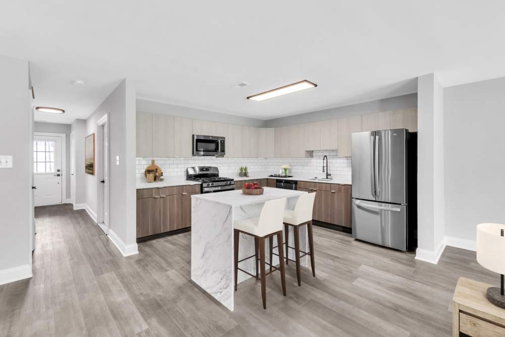 Lounge area with a fireplace and a wall mounted tv at The Fairways Apartments and Townhomes in Thorndale, Pennsylvania