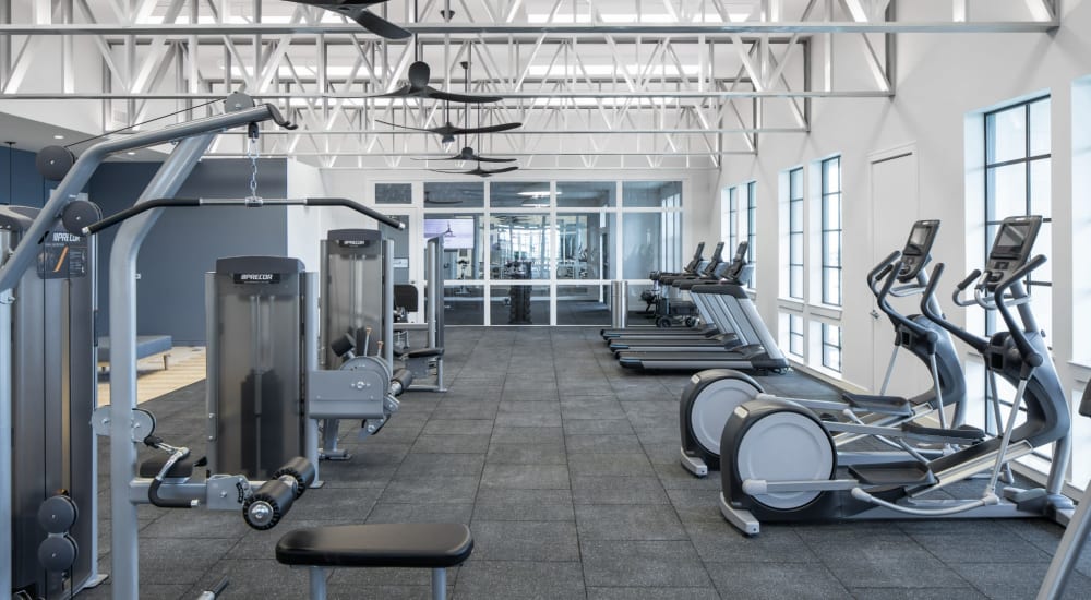 Community fitness center with cardio and weight machines at Bellrock Sawyer Yards in Houston, Texas