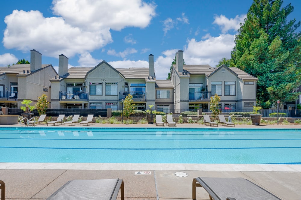A poolside sundeck with plenty of lounge chairs at Larkspur Woods in Sacramento, California